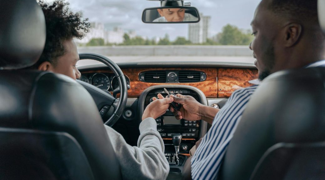 Man in Gray Long Sleeve Shirt Driving Car